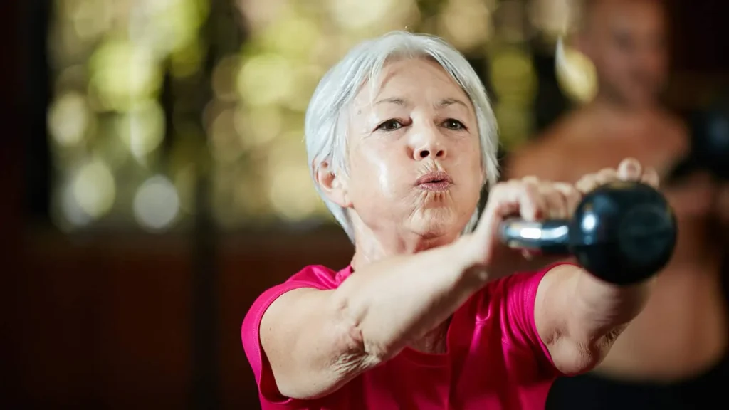 Toning Bingo Wings: Effective Exercises and Tips for Achieving Sleeker Arms 2 Person performing arm exercises with dumbbells Walton on the Hill